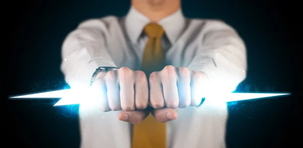 Business man holding glowing lightning bolt in his hands — Stock Photo, Image