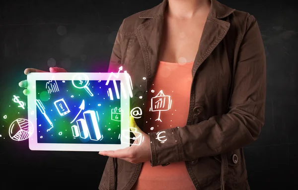 Young person holding tablet with graph and chart symbols — Stock Photo, Image