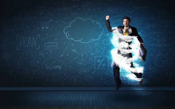 Happy business man jumping with storm cloud around him — Stock Photo, Image