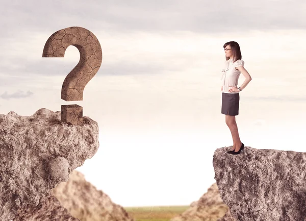 Businesswoman on rock mountain with a question mark — Stock Photo, Image