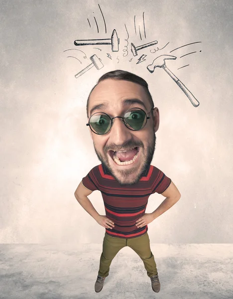 Big head person with drawn hammers — Stock Photo, Image