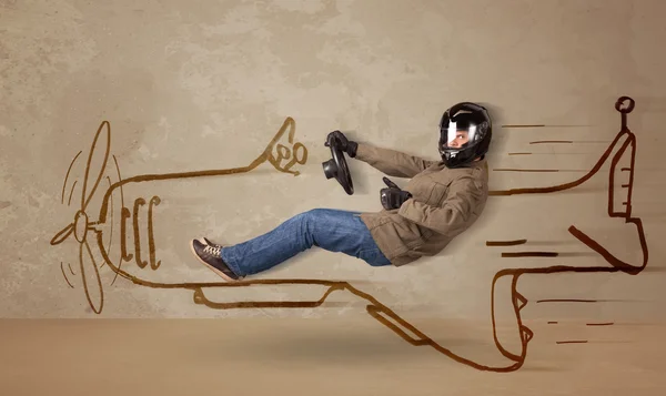 Забавный пилот за рулем нарисованного вручную самолета на стене — стоковое фото