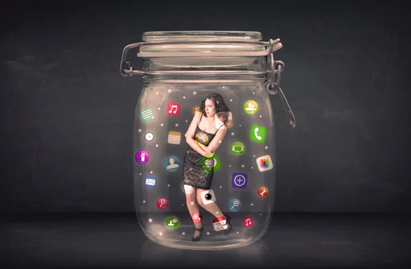 Businesswoman captured in a glass jar with colourful app icons c — Stock Photo, Image