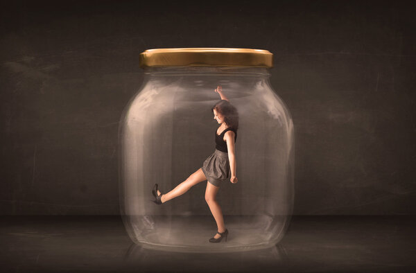 Businesswoman captured in a glass jar concept