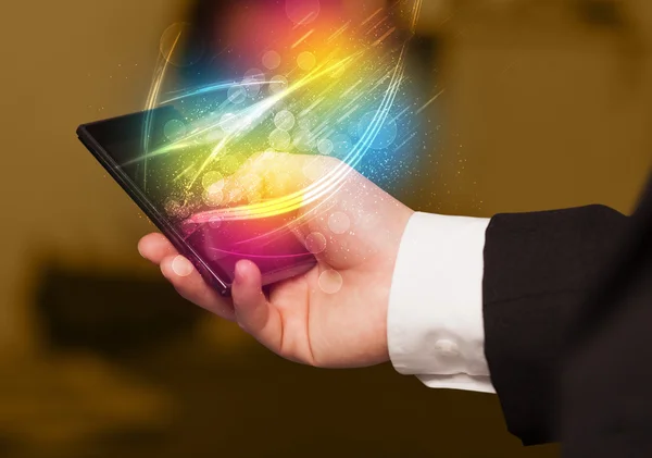 Hand holding smart phone with abstract glowing lines — Stock Photo, Image