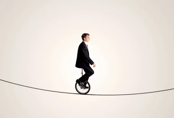 Extreme business man riding unicycle on a rope — Stock Photo, Image