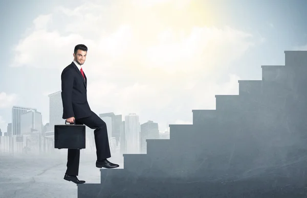 Businessman climbing up a concrete staircase concept — Stock Photo, Image