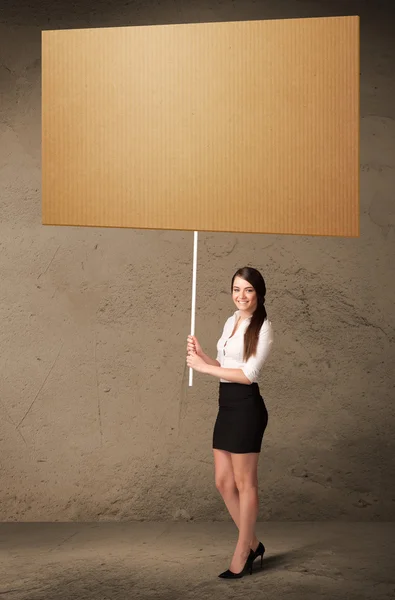 Businesswoman with blank cardboard — Stock Photo, Image