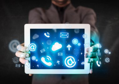 Mavi teknoloji simgeleri ve sembolleri olan bir tablet tutan kişi