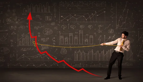 Zakenman trekt een rode pijl rechtop met een touw — Stockfoto