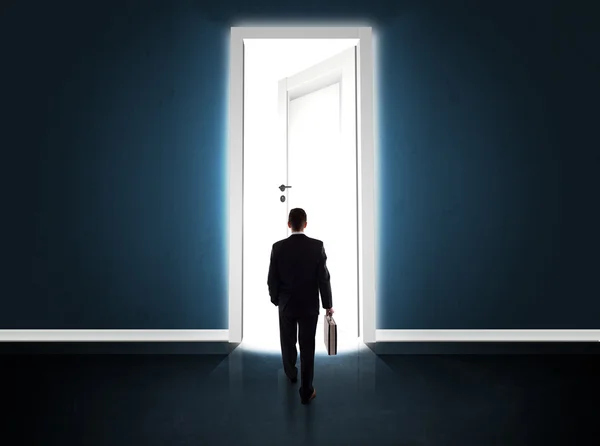 Business man looking at big bright opened door — Stock Photo, Image