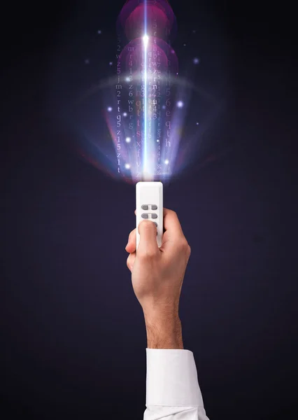 Hand with remote control and shining numbers — Stock Photo, Image