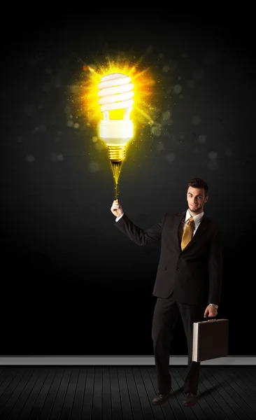 Businessman with an eco-friendly bulb — Stock Photo, Image