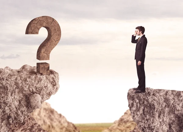 Businessman on rock mountain with a question mark — Stock Photo, Image