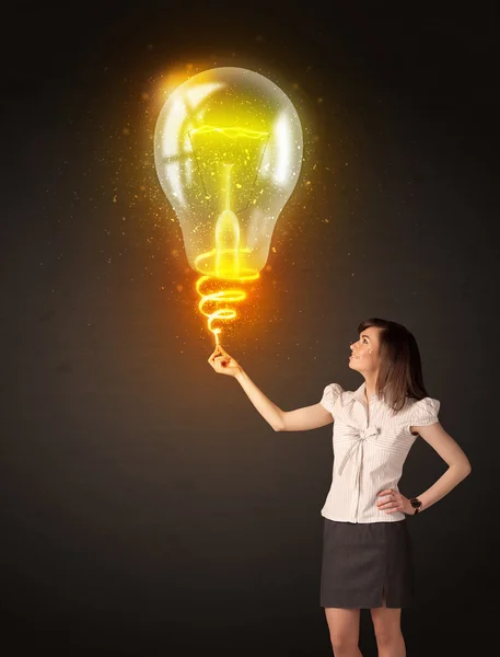 Businesswoman with an idea bulb — Stock Photo, Image