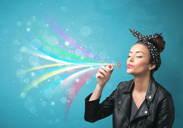 Beautiful girl blowing abstract colorful bubbles and lines — Stock Photo, Image