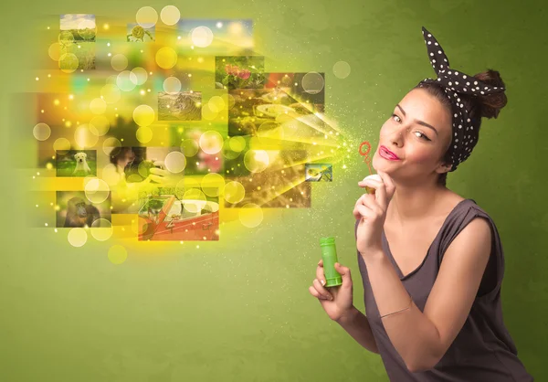 Cute girl blowing colourful glowing memory picture concept — Stock Photo, Image