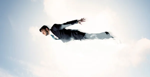 Business man flying like a superhero in clouds on the sky — Stock Photo, Image