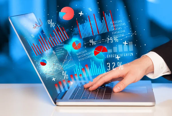 Hand typing on modern laptop notebook computer with graph icons — Stock Photo, Image