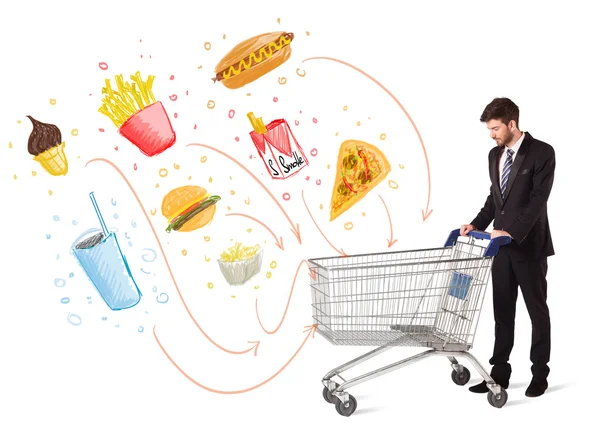 Man with shopping cart with toxic junk food — Stock Photo, Image