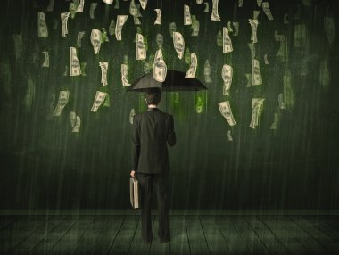 Bir dolar yağmur konseptinde şemsiyesi olan bir iş adamı