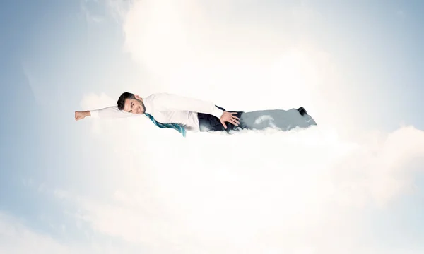 Business man flying like a superhero in clouds on the sky — Stock Photo, Image