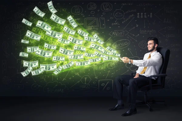 Businessman sitting in chair holding tablet with dollar bills co — Stock Photo, Image