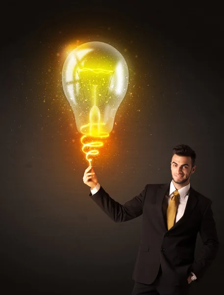 Businessman with an idea bulb — Stock Photo, Image