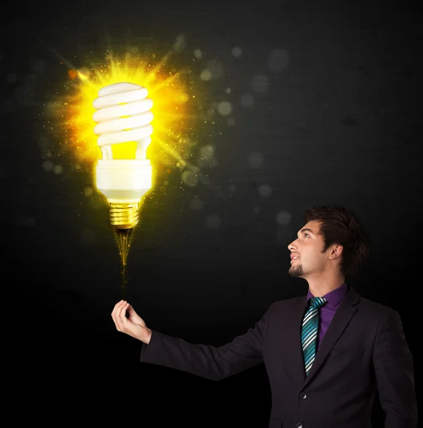 Businessman with an eco-friendly bulb — Stock Photo, Image