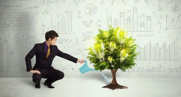 Business man pouring water on lightbulb growing tree — Stock Photo, Image