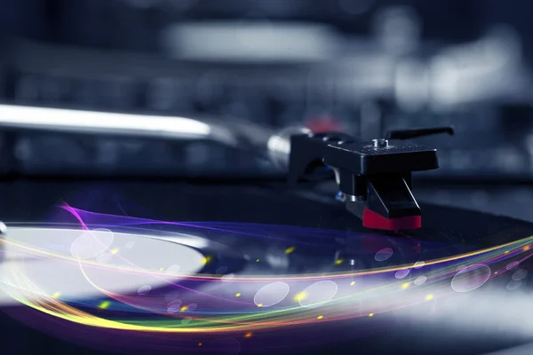 Turntable playing vinyl with glowing abstract lines — Stock Photo, Image