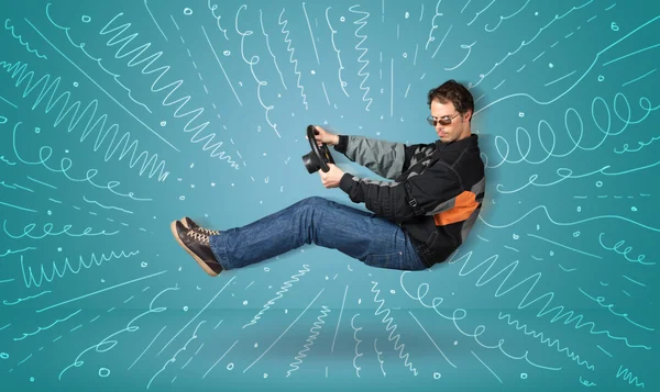 Funny guy drives an imaginary vehicle with drawn lines around hi — Stock Photo, Image