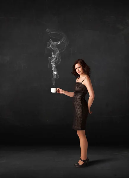 Businesswoman holding a white steamy cup — Stock Photo, Image