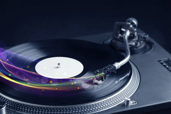 stock image Turntable playing vinyl with glowing abstract lines