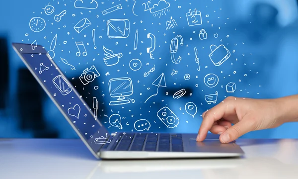 Laptop computer wtih hand drawn icons and symbols — Stock Photo, Image