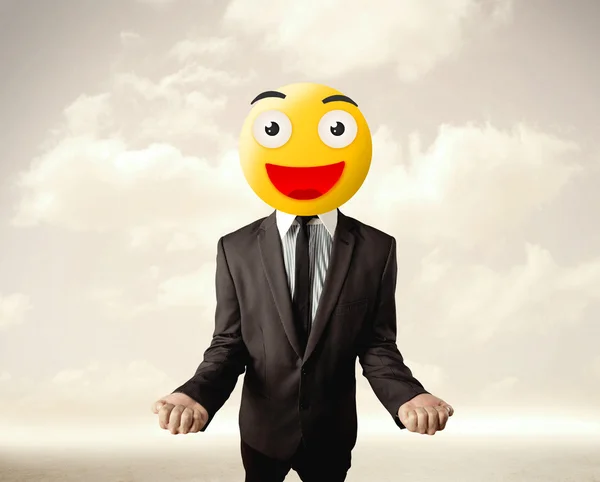 Businessman wears yellow smiley face — Stock Photo, Image