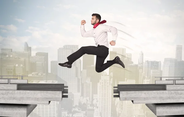 Energetic business man jumping over a bridge with gap — Stock Photo, Image