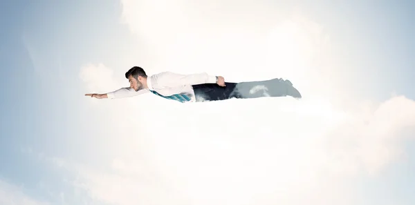 Business man flying like a superhero in clouds on the sky — Stock Photo, Image