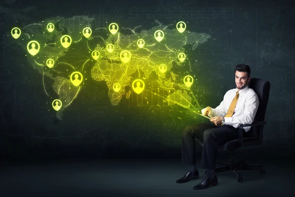 Businessman in office with tablet and social network world map — Stock Photo, Image