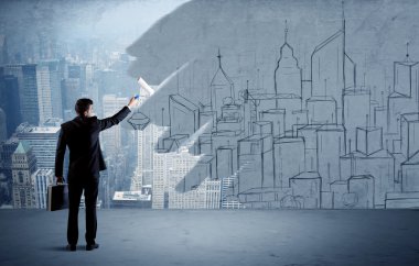 Zarif satıcı şehri duvarda yeniden boyuyor.