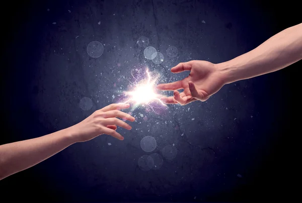 Hands reaching to light a spark — Stock Photo, Image