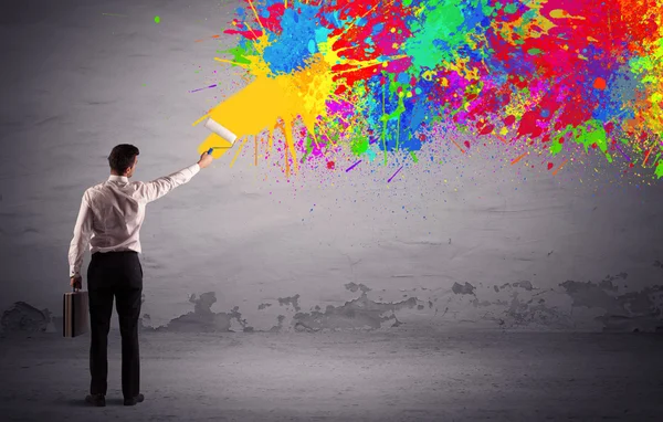 Sales person painting colorful splatter — Stock Photo, Image