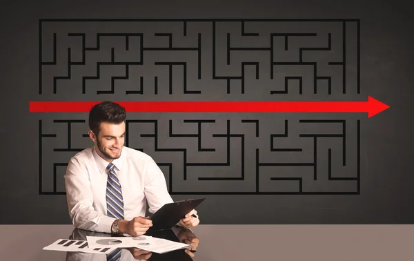 Businessman with a solved puzzle in background — Stock Photo, Image