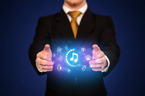 Man holding digital multimedia icons — Stock Photo, Image