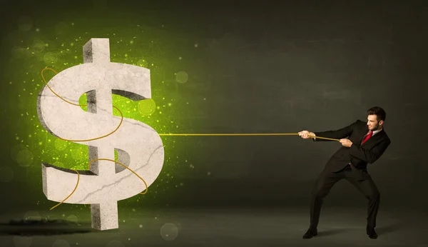Business man pulling a big green dollar sign — Stock Photo, Image