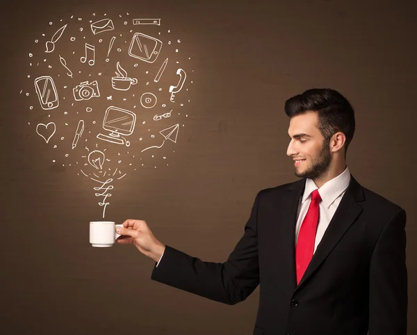 Businessman holding a white cup with social media icons — Stock Photo, Image