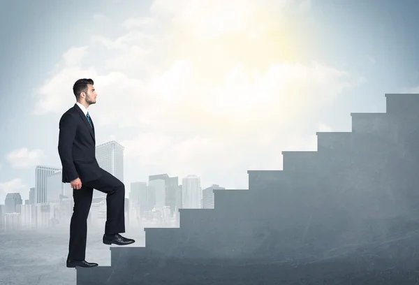 Businessman climbing up a concrete staircase concept — Stock Photo, Image