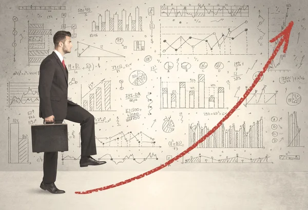 Affärsman klättring på röd graf pilen koncept — Stockfoto