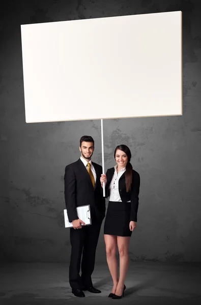 Business couple with blank whiteboard — Stock Photo, Image