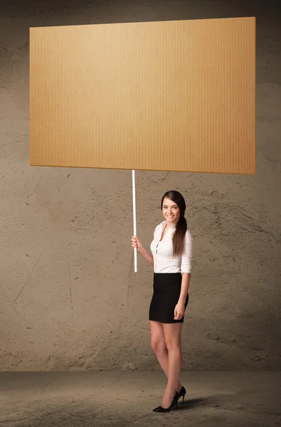 Businesswoman with blank cardboard — Stock Photo, Image